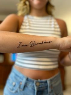 a woman with a tattoo on her arm that says i am babbler in cursive writing