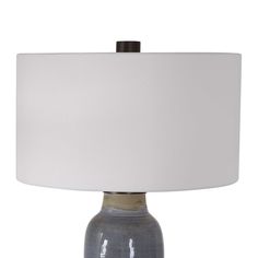 a table lamp with a white shade on it