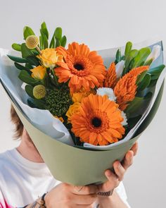 a man holding a bouquet of flowers in his hands