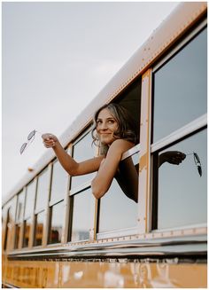 a woman leaning out the window of a school bus