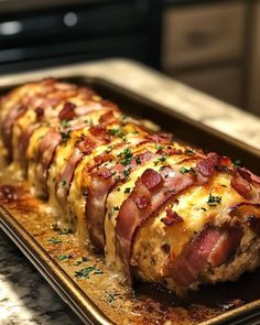 bacon wrapped in cheese on a baking sheet