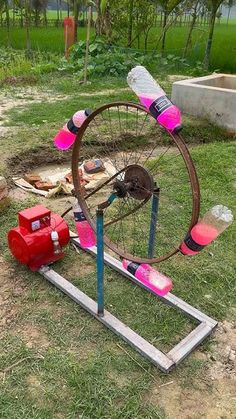 an old spinning wheel is sitting on the ground in front of a fire hydrant