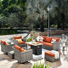 an outdoor patio furniture set with orange cushions