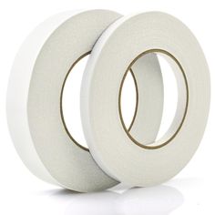 two rolls of white cloth tape sitting next to each other