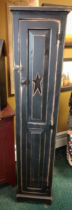 an old wooden armoire sitting on top of a carpeted floor next to a dresser