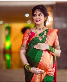 a woman in an orange and green sari