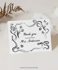 thank you from the future mr and mrs anderson card with flowers on it, next to a plant