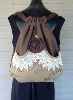 a brown and white purse on top of a mannequin