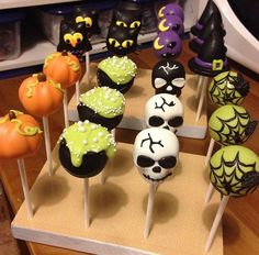 there are many halloween cake pops on the table