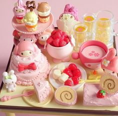 a table topped with lots of cakes and desserts