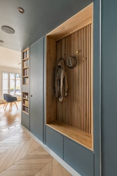 a wooden bench sitting in the middle of a room next to a bookshelf