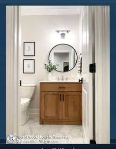 a bathroom with a sink, mirror and toilet in it's doorway way to another room