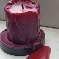 a red candle sitting on top of a table