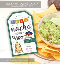 a bowl of guacamole and chips on a plate with a gift tag