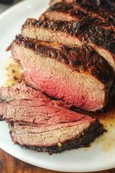 sliced meat sitting on top of a white plate