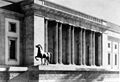 an old black and white photo of a horse statue in front of a large building