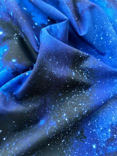 a blue and black fabric with stars on the top, as if it were in outer space