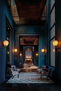 the hallway is decorated in blue and has two chairs on either side of the door