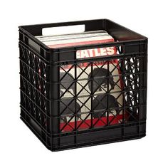 a black basket with magazines in it