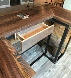 a wooden desk with two open drawers on it