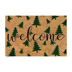 a welcome mat with pine trees on it and the word welcome written in black ink