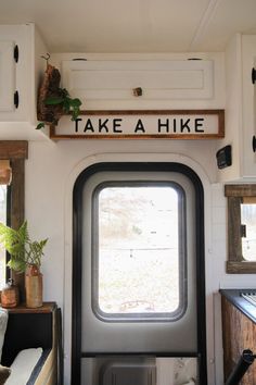 there is a sign above the door that says take a hike on the wall next to the window