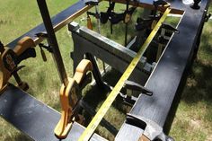 tools are sitting on top of a bench in the grass