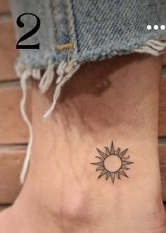 a small sun tattoo on the ankle