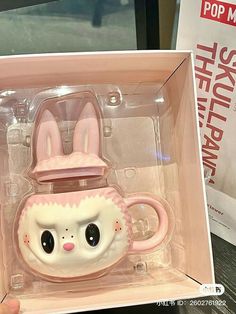 a pink and white bunny mug in a box