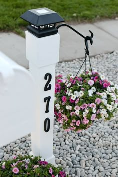 a white post with flowers hanging from it's side and the number twenty two