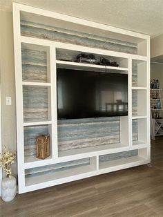 a large entertainment center with a flat screen tv mounted on it's side wall