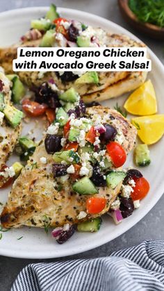 a white plate topped with grilled chicken covered in feta cheese and black olives