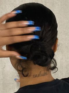 a woman with blue nail polish on her nails