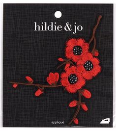 a red flower on a black background with the words hide & jo in white lettering