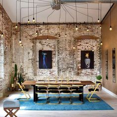 a dining room with brick walls and chairs