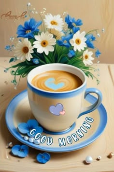 a painting of a cup of coffee with blue flowers in the center and good morning written on it