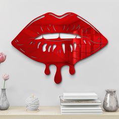 a red wall clock with dripping lipstick on it's face next to vases and flowers