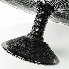 a black and white photo of an object that looks like a fish's tail