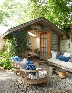 an outdoor living area with couches and chairs