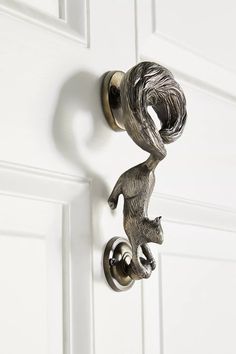 a metal door handle with a squirrel on it