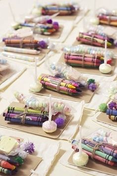 there are many crayons on the table with candles and other things in them