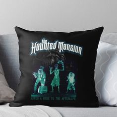 the haunted mansion throw pillow on a couch