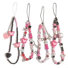 four different necklaces hanging from hooks on a white background, one with pink and black beads