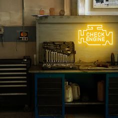 there is a neon sign that says check engine on the wall