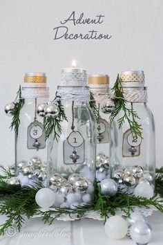 three glass bottles with ornaments in them and the words, christmas decorations are on display