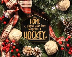 the wreath is decorated with pine cones, berries and plaid ribbon as well as an ornament