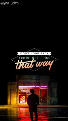 a man standing in front of a store with the words don't look back you're not going that way