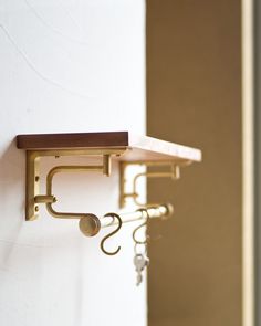 an instagram photo of a shelf with keys hanging from it