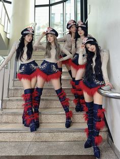 the girls are dressed in red, white and blue outfits while posing on some stairs