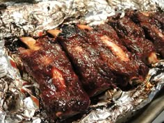 some meat is sitting on tin foil and ready to be grilled in the oven